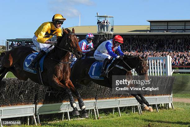 Richard Cully riding No Song No Supper jumps beside Martin Kelly riding Thubiaan before winning Race 7, Grand Annual Steeplechase during Grand Annual...