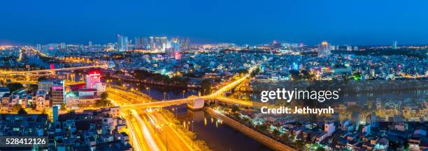 saigon panorama of the dong tay avenue and y brigde cross the canal at night - benjamin brand stock pictures, royalty-free photos & images