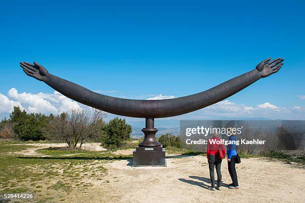 People looking at the bronze artwork at the Chateau de Lacoste above the hillside village of Lacoste in the Luberon in the Provence-Alpes-C��te...