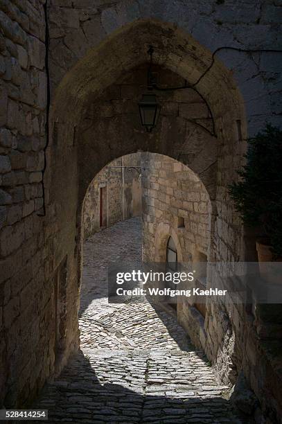 Cobblestone street in the hillside village of Lacoste in the Luberon in the Provence-Alpes-C��te d'Azur region in southeastern France.