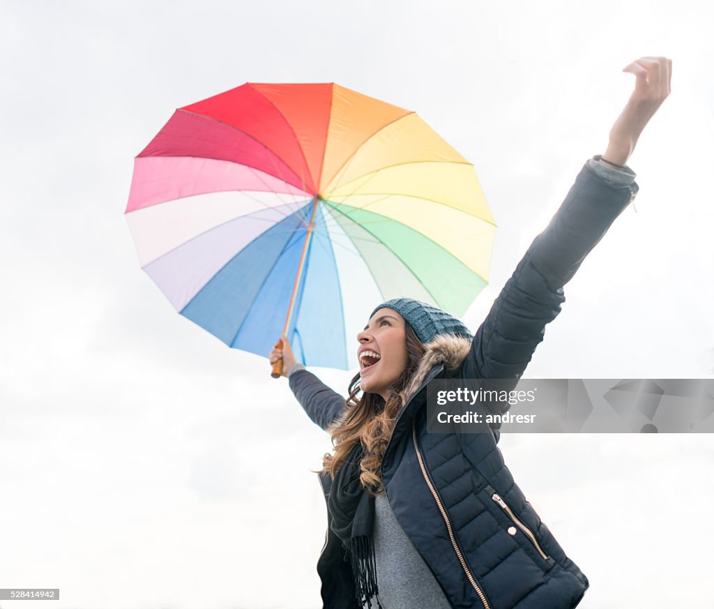 Happy woman enjoying the rain