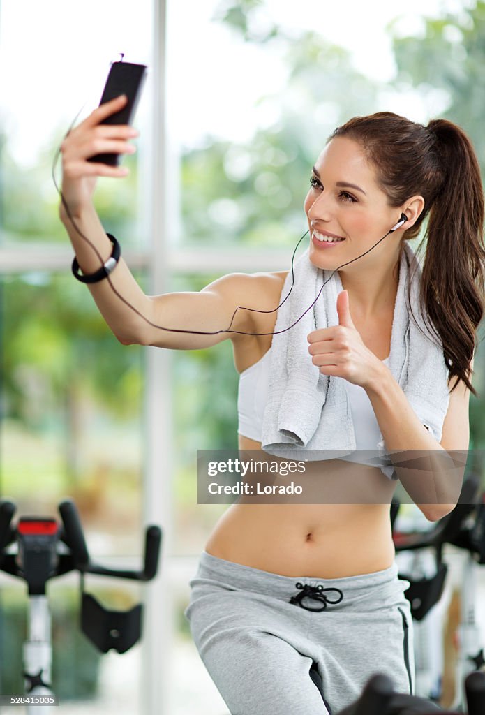 Woman taking a selfie in gym