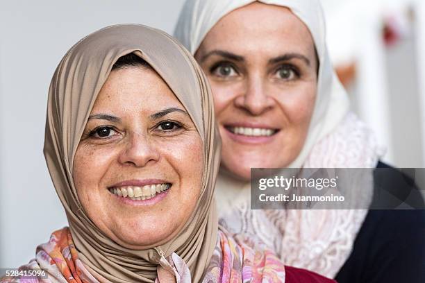 two muslim women - only mature women stock pictures, royalty-free photos & images