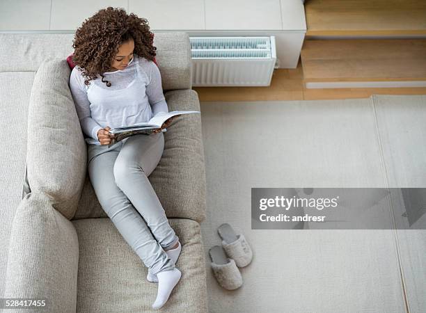 woman relaxing at home - magazines stockfoto's en -beelden
