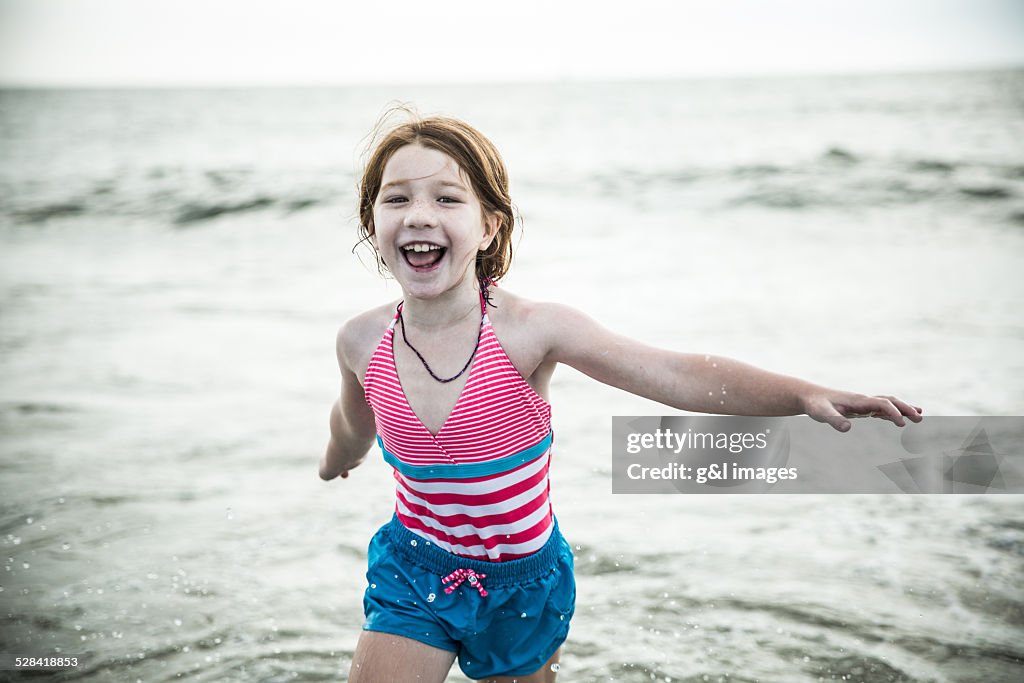Girl (7yrs) playing on beach
