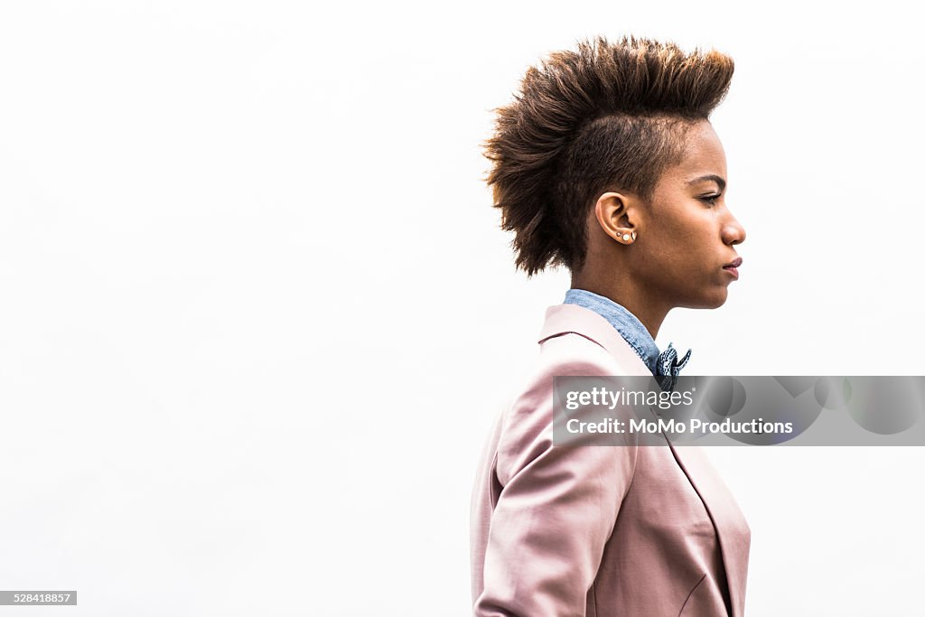 Portrait of young woman on plain background