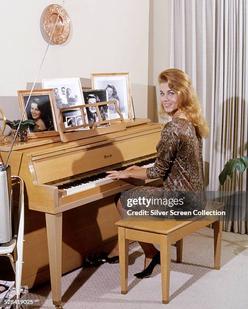 Swedish-American actress Ann-Margret playing a piano, circa 1964.