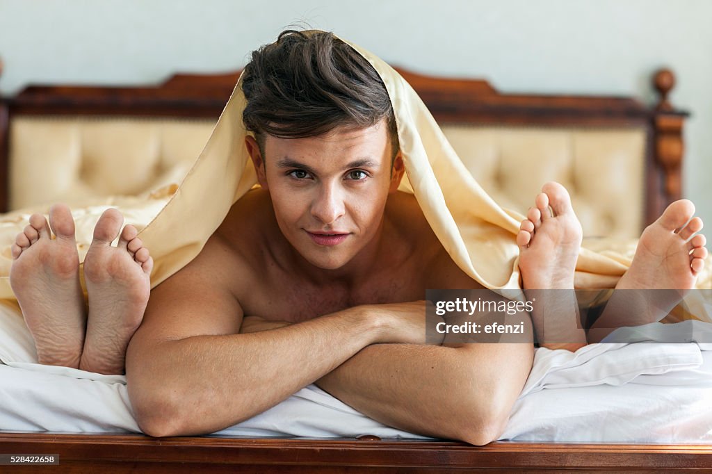Handsome Man In Bed With Two Women