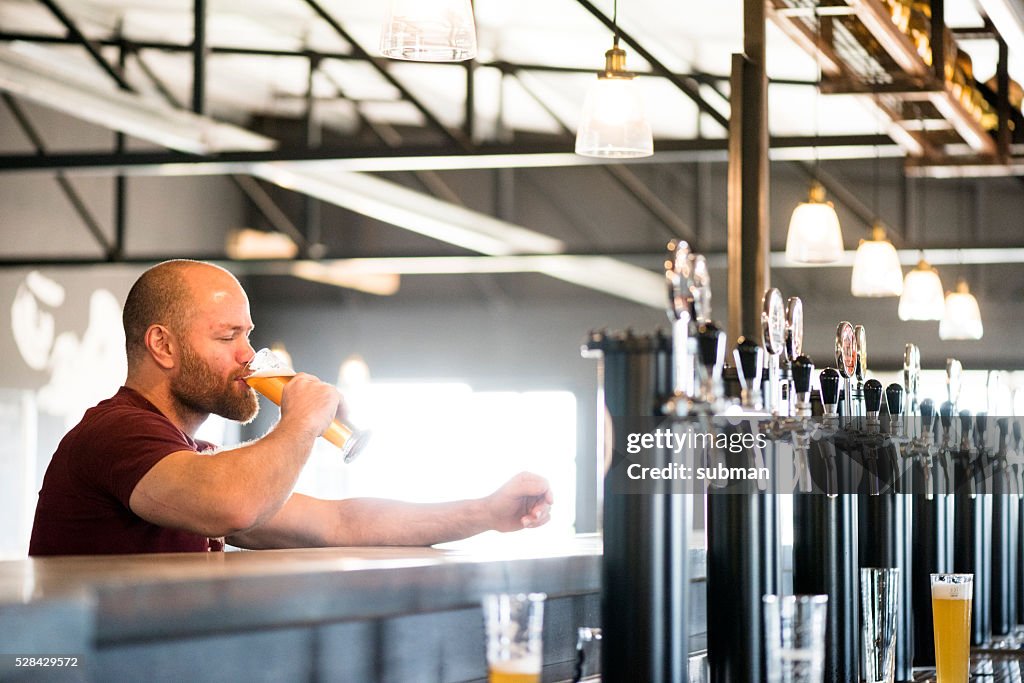 Adult Male Enjoying A Good Craft Beer At The Brewery