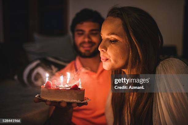 make a wish! - cool couple in apartment stock pictures, royalty-free photos & images