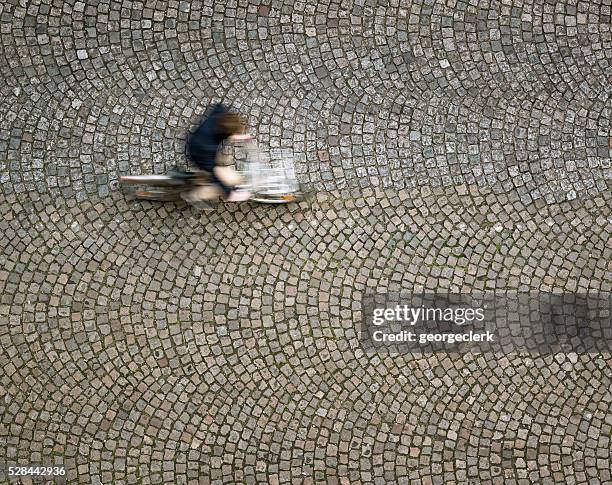 cyclist on the move, photographed from directly above - kassei stockfoto's en -beelden