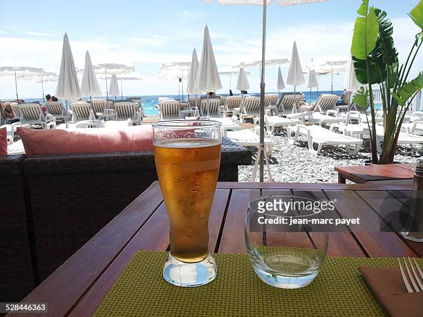 Beer served on a table facing the seafront on the french Riviera in a beach bar in France