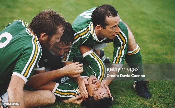 Eire goalscorer Mickey Walsh is congratulated after scoring the winning goal by from left Tony Grealish, Michael Robinson and Liam Brady during a...