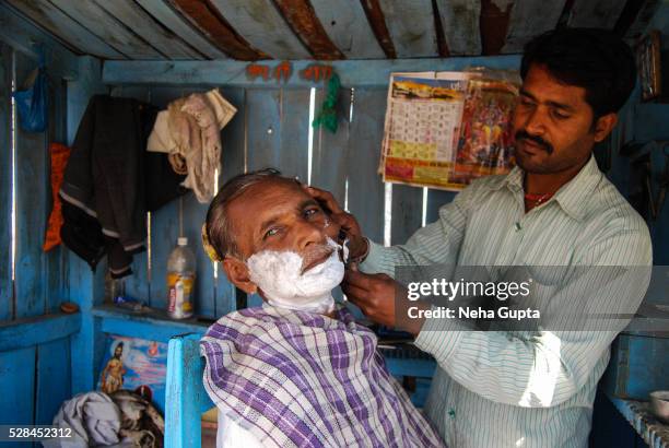 a barber at work - damoh stock pictures, royalty-free photos & images