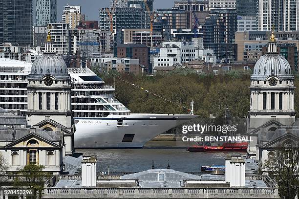 The Viking Sea cruise ship is guided by tug boats along the River Thames towards Greenwhich Pier in east London on May 5 ahead of its official naming...