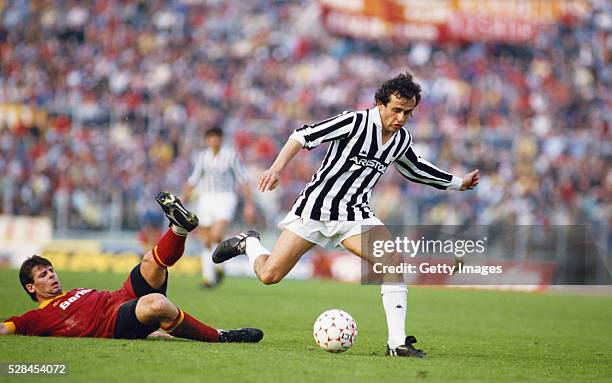 Sebastiano Nela of AS Roma attempts to tackle Michel Platini of Juventus during a Seria A match in the 1985/86 season at the Olympic Stadium in Rome,...