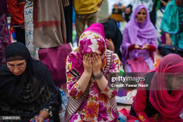 Kashmiri Muslim women pray outside the Hazratbal Shrine on the Mehraj-u-Alam, which marks ascension day, the journey from Earth to Heaven of the...