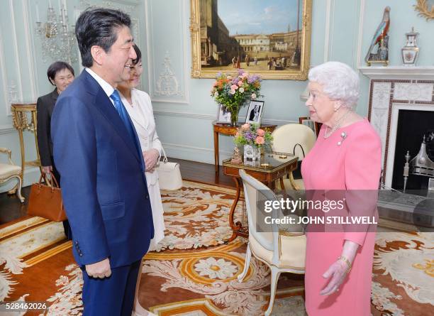 Britain's Queen Elizabeth II hosts a private audience with Japanese Prime Minister Shinzo Abe, and his wife Akie, at Buckingham Palace in central...