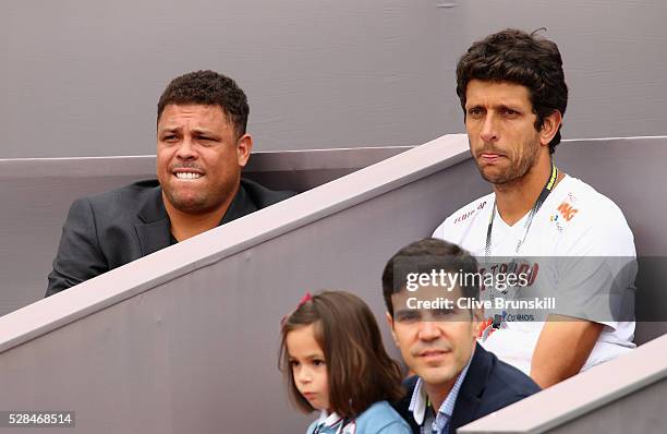 Ex Brazilian and Real Madrid footballer Ronaldo and Brazilian tennis player Marcelo Melo watch Jamie Murray of Great Britain and Bruno Soares of...