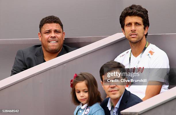 Ex Brazilian and Real Madrid footballer Ronaldo and Brazilian tennis player Marcelo Melo watch Jamie Murray of Great Britain and Bruno Soares of...