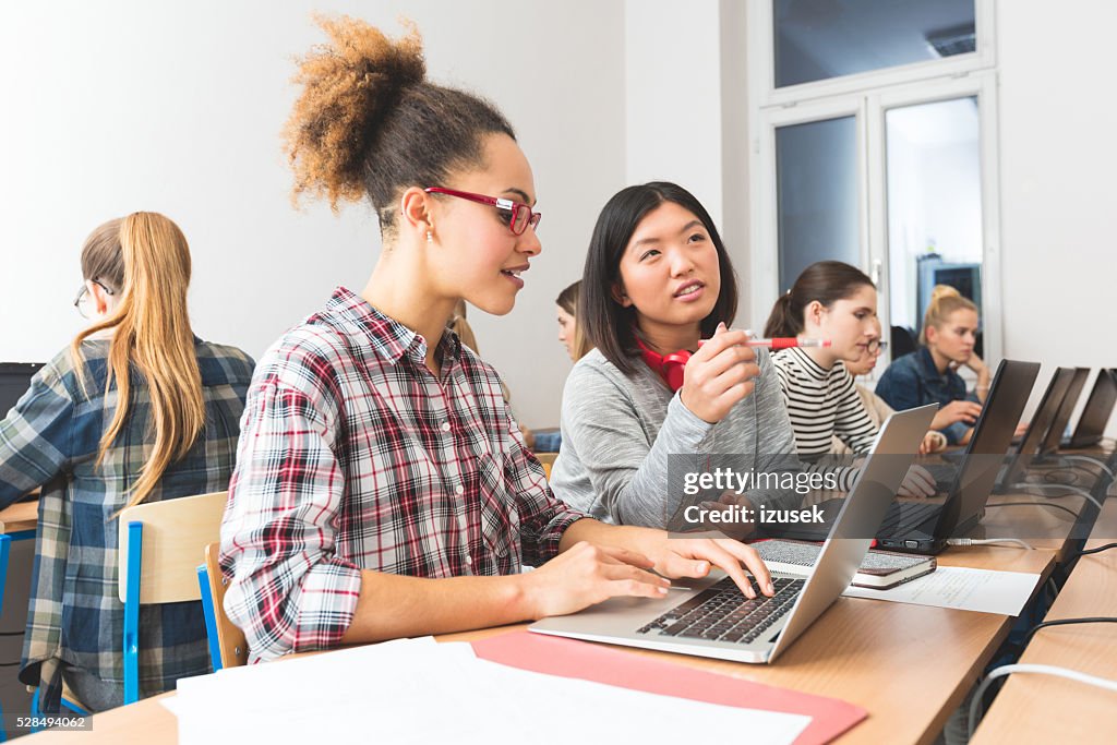 Female students learning computer programming