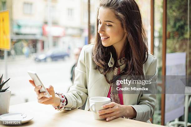 girl texting on cell phone - only women videos stock pictures, royalty-free photos & images