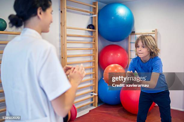 rehabilitation exercises with ball - child having medical bones stock pictures, royalty-free photos & images