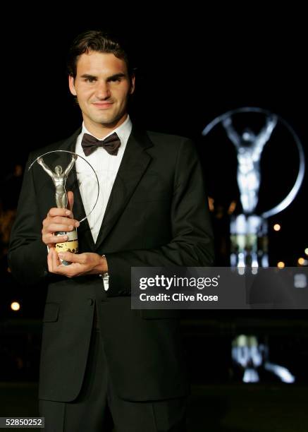 Tennis star Roger Federer poses for photographers with his Sportsman of the Year award during the Laureus World Sports Awards ceremony at the Estoril...