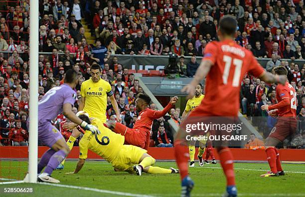 Liverpool's English striker Daniel Sturridge strikes the ball towards the goal which makes contact with Villarreal's midfielder Bruno Soriano to...