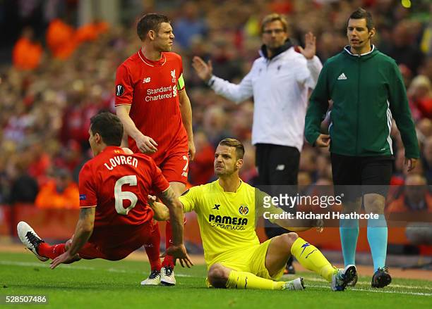 Roberto Soldado of Villarreal and Dejan Lovren of Liverpool clash during the UEFA Europa League semi final second leg match between Liverpool and...
