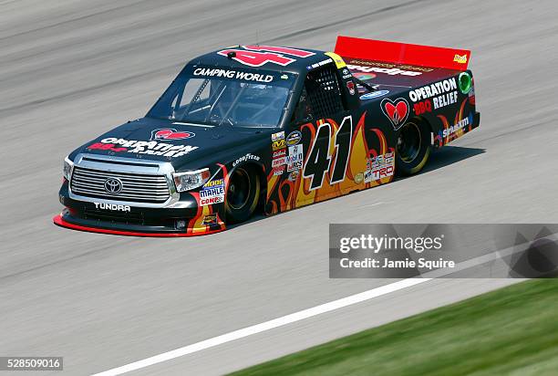 Ben Rhodes, driver of the Operation BBQ Relief Toyota, practices for the NASCAR Camping World Truck Series 16th Annual Toyota Tundra 250 on May 05,...