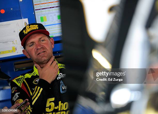 Clint Bowyer, driver of the 5-Hour Energy Chevrolet, looks at his car after a practice sessions for the Toyota Tundra 250 at Kansas Speedway on May...