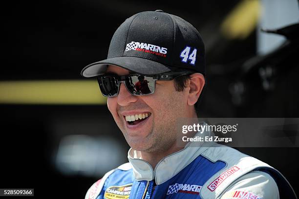 Tommy Joe Martins, driver of the Diamond Gusset Jeans Chevrolet, talks to a member of his team after a practice sessions for the Toyota Tundra 250 at...