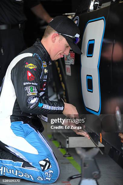 John Hunter Nemechek, driver of the Andy's Frozen Custard Chevrolet, works on his car after a practice sessions for the Toyota Tundra 250 at Kansas...