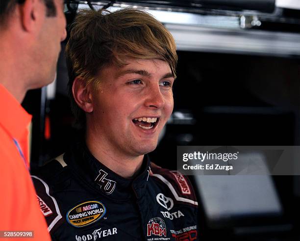 William Byron, driver of the Liberty University Toyota, talks to a member of his crew after a practice sessions for the Toyota Tundra 250 at Kansas...