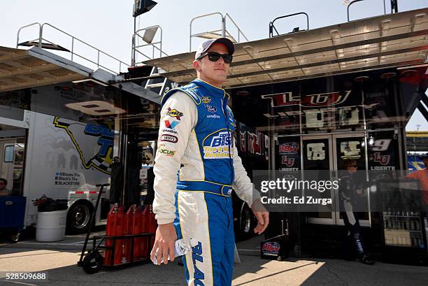 Parker Kligerman, driver of the, walks the garage area during a practice sessions for the Toyota Tundra 250 at Kansas Speedway on May 5, 2016 in...
