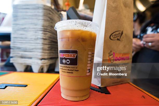 An order sits at the drive thru window inside a Dunkin' Donuts Inc. Location in Ramsey, New Jersey, U.S., on Thursday, May 5, 2016. Dunkin' Brands...