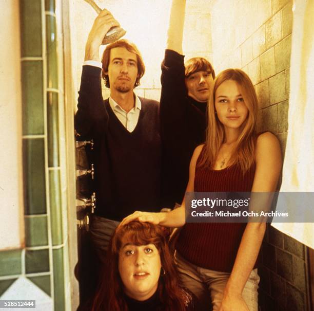 Mama Cass, John Phillips, Denny Doherty, and Michelle Phillips of the rock and roll band "The Mamas And The Papas" pose for a portrait session in a...