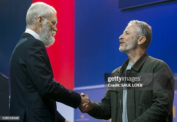 Former talk show hosts David Letterman and Jon Stewart shake hands during a celebration of the 5th anniversary of Joining Forces and the 75th...