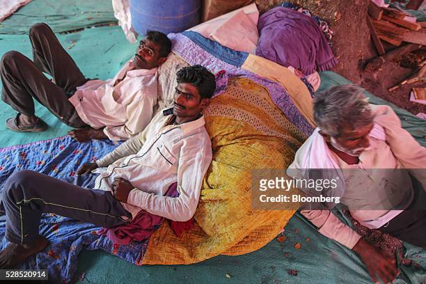Farmer Vijay Jadhav, center, and members of his family sit inside a temporary suburban camp, set up by local political party Shiv Sena for the rural...