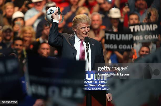 Republican Presidential candidate Donald Trump shos off a hard hat during hie rally at the Charleston Civic Center on May 5, 2016 in Charleston, West...