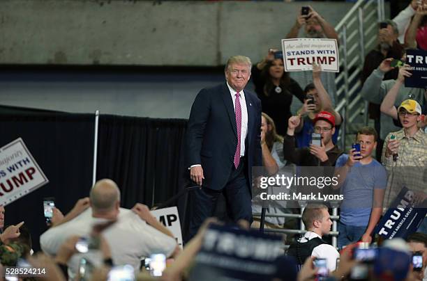 Republican Presidential candidate Donald Trump pauses to look at the crowd aas he arrives for his rally at the Charleston Civic Center on May 5, 2016...