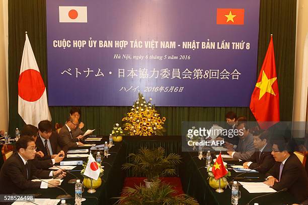 Japan's Foreign Minister Fumio Kishida and his Vietnamese counterpart Pham Binh Minh attend a Vietnam-Japan Cooperation Committee meeting at the...