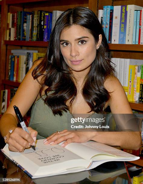 Diane Guerrero signs copies of her book "In the Country We Love: My Family Divided " at Books and Books on May 5, 2016 in Coral Gables, Florida.