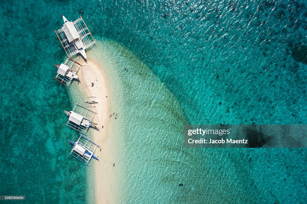 Aerial view of outrigger boats on sand bar