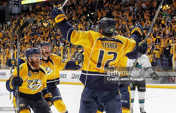 Ryan Ellis and Mattias Ekholm celebrate with Mike Fisher of the Nashville Predators after his game winning third overtime goal against the San Jose...
