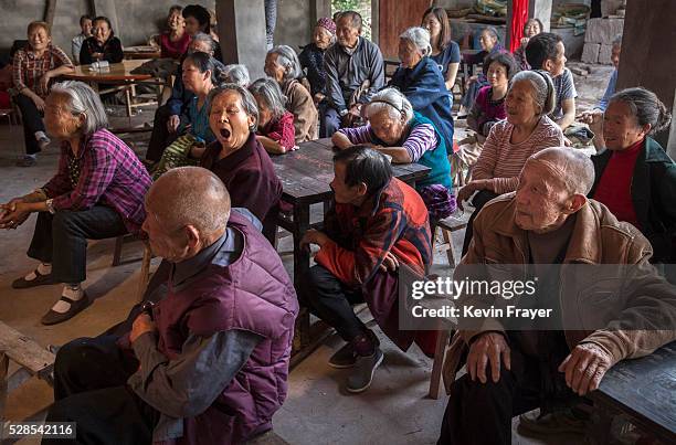 Local villagers watch a Sichuan Opera performed by the Jinyuan Opera Company at the Dongyue Temple on May 2, 2016 in Cangshan, Sichuan province,...