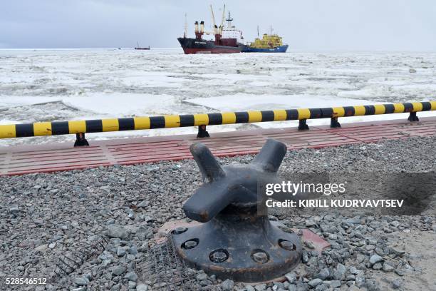 Picture taken on May 5, 2016 shows the icebreaker Tor leading a cargo ship at the port of Sabetta in the Kara Sea shore line on the Yamal Peninsula...