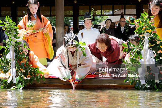 Waka Nishimura, wearing a 12-layered ceremonial kimono called 'Junihitoe', performs the 'Misogi-no-Gi ' at Kamigamo Jinja Shrine ahead of Aoi Matsuri...