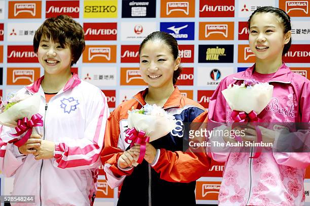 Second place Mai Murakami and Winner Asuka Teramoto and Third place Aiko Sugihara pose for photographs at the medal ceremony during day one of the...